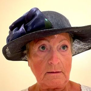 Elegant wide brim hat with satin band & large bow. Brim can be bent.